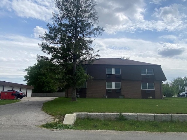 88 1st Ave, Atkins, IA 52206 - view of front of home with a front lawn, a garage, and brick siding