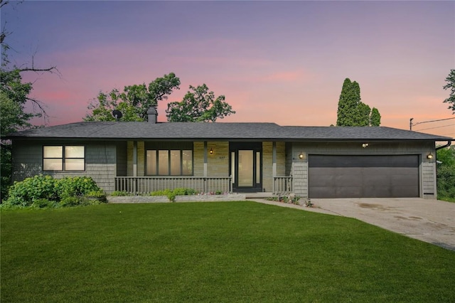1649 Memorial Dr SE, Cedar Rapids, IA 52403 - ranch-style house with a porch, an attached garage, concrete driveway, and a lawn