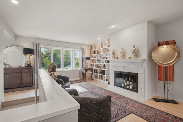 1649 Memorial Dr SE, Cedar Rapids, IA 52403 - living area with wood finished floors, recessed lighting, a tile fireplace, and baseboards