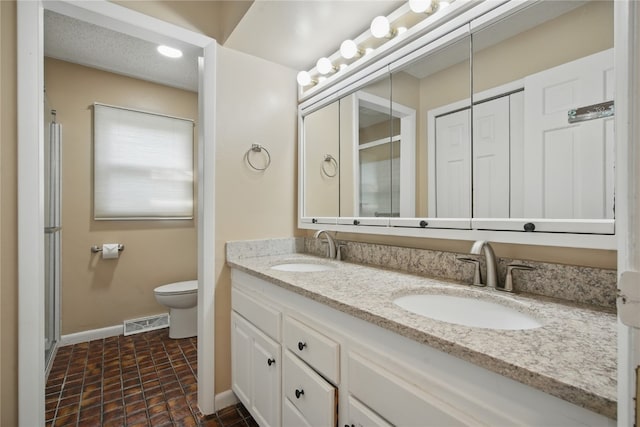 1649 Memorial Dr SE, Cedar Rapids, IA 52403 - full bath featuring double vanity, toilet, baseboards, and a shower with door
