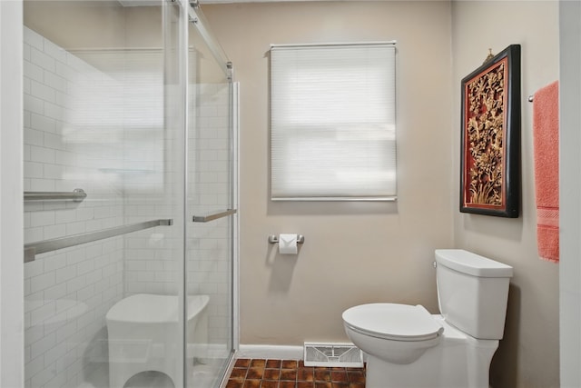 1649 Memorial Dr SE, Cedar Rapids, IA 52403 - bathroom with toilet, a shower stall, baseboards, and tile patterned floors