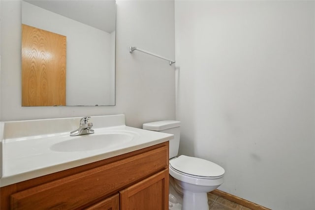1450 Tower Ln NE, Cedar Rapids, IA 52402 - bathroom featuring vanity, toilet, tile patterned flooring, and baseboards