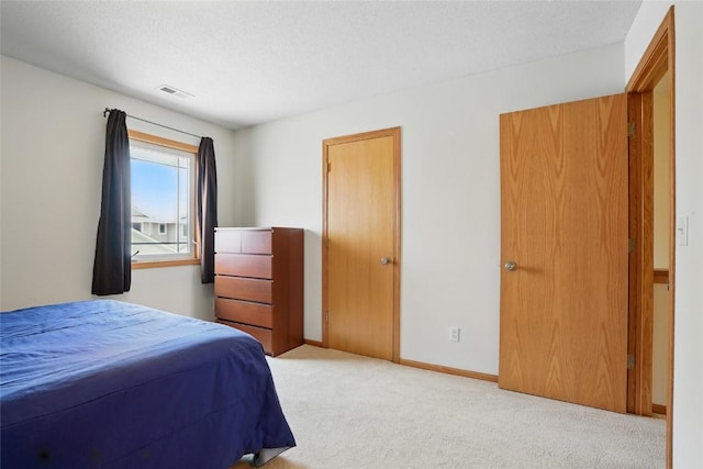 1450 Tower Ln NE, Cedar Rapids, IA 52402 - carpeted bedroom featuring baseboards and a textured ceiling