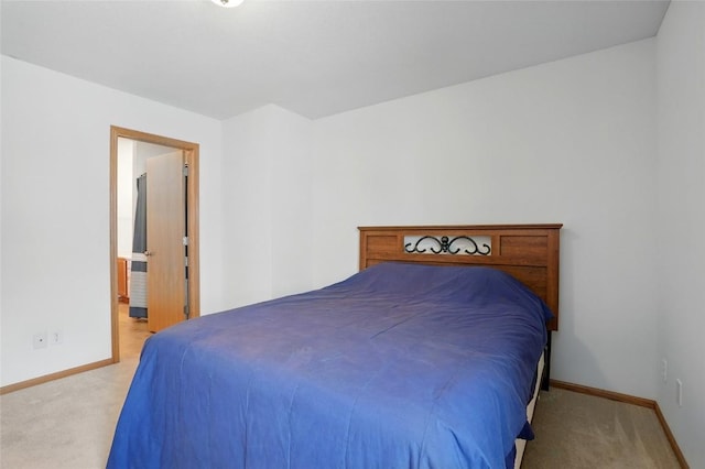 1450 Tower Ln NE, Cedar Rapids, IA 52402 - bedroom with light colored carpet, baseboards, and ensuite bathroom