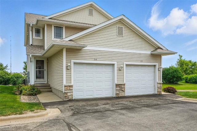 1450 Tower Ln NE, Cedar Rapids, IA 52402 - view of front of property featuring asphalt driveway, a shingled roof, a garage, and entry steps