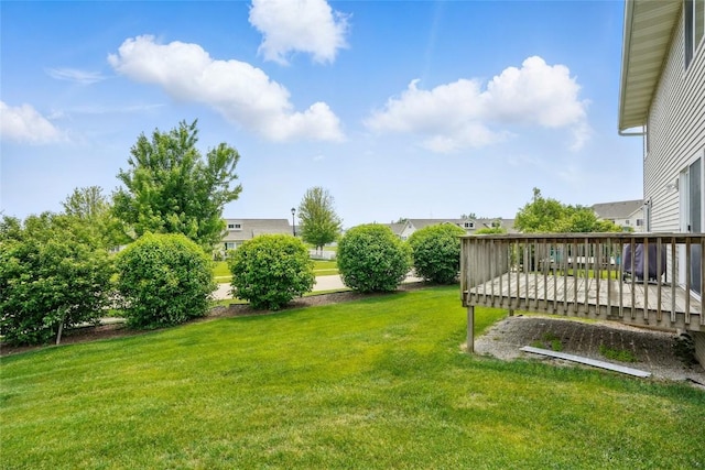 1450 Tower Ln NE, Cedar Rapids, IA 52402 - view of grassy yard with a wooden deck