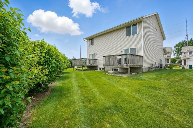 1450 Tower Ln NE, Cedar Rapids, IA 52402 - back of property featuring cooling unit, a deck, and a yard