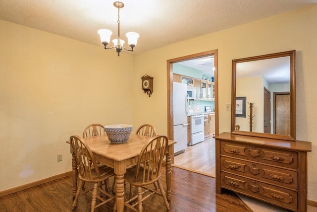 4320 Maureen Ct SE Unit 176, Cedar Rapids, IA 52403 - dining space with wood finished floors, a chandelier, and baseboards
