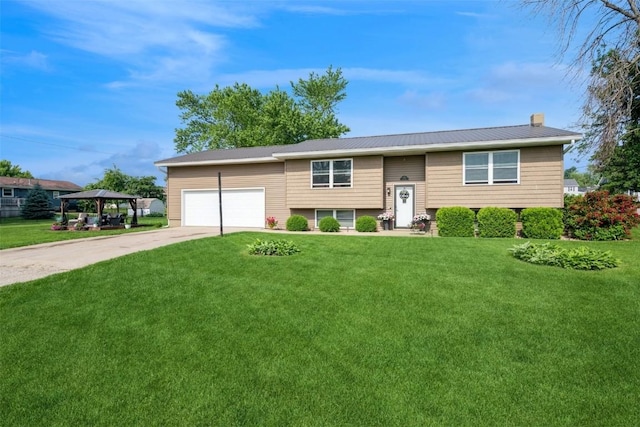 303 6th Ave, Newhall, IA 52315 - split foyer home featuring concrete driveway, a front yard, a chimney, and a garage
