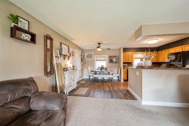 303 6th Ave, Newhall, IA 52315 - kitchen with open floor plan, dark carpet, ceiling fan, black microwave, and a peninsula