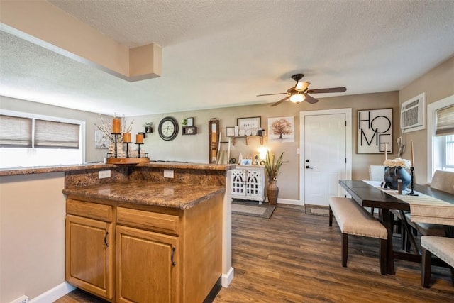 303 6th Ave, Newhall, IA 52315 - kitchen featuring a ceiling fan, dark wood-type flooring, a textured ceiling, baseboards, and an AC wall unit