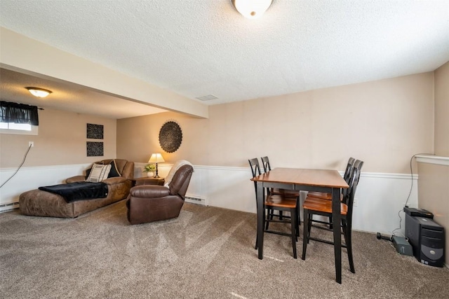 303 6th Ave, Newhall, IA 52315 - dining room with a baseboard radiator, carpet, and a textured ceiling