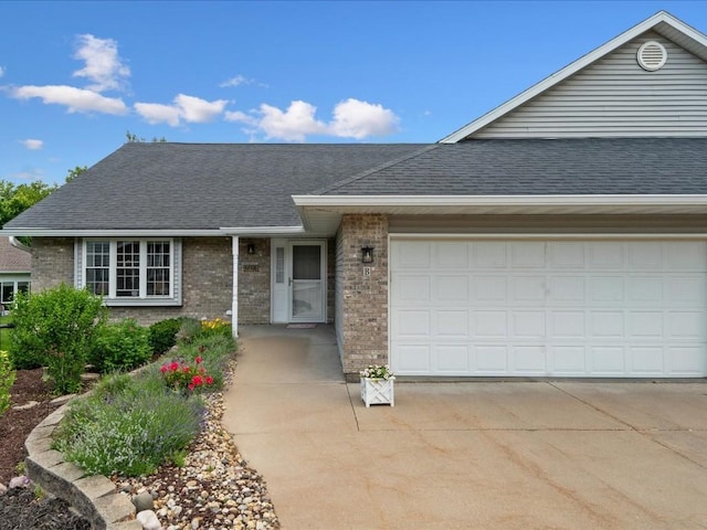 501 Washington Ct SW Unit B, Mount Vernon, IA 52314 - ranch-style house featuring brick siding, driveway, roof with shingles, and an attached garage