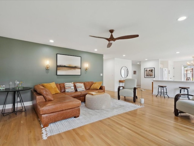501 Washington Ct SW Unit B, Mount Vernon, IA 52314 - living room with light wood-style flooring, ceiling fan, recessed lighting, baseboards, and a chandelier