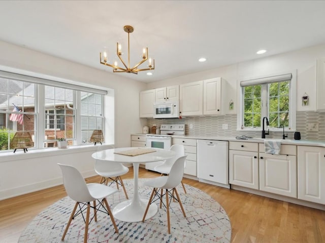 501 Washington Ct SW Unit B, Mount Vernon, IA 52314 - dining area with a chandelier, light wood-style flooring, recessed lighting, and baseboards