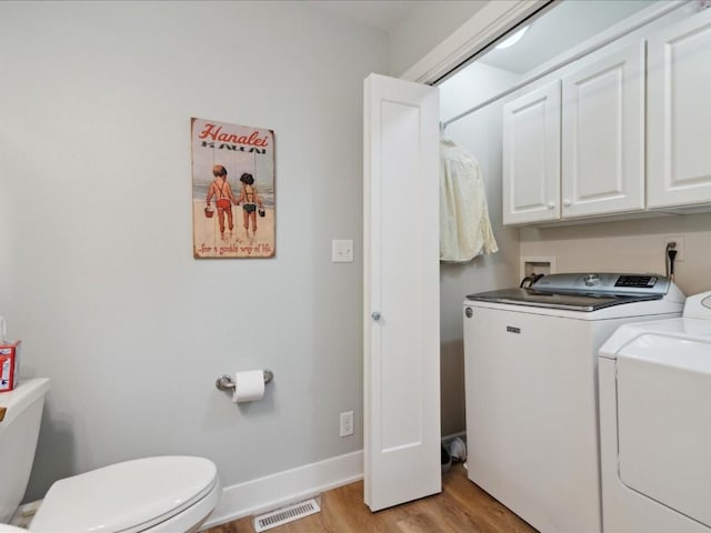 501 Washington Ct SW Unit B, Mount Vernon, IA 52314 - laundry room featuring independent washer and dryer, light wood-type flooring, cabinet space, and baseboards