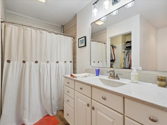 501 Washington Ct SW Unit B, Mount Vernon, IA 52314 - full bathroom featuring vanity, wood finished floors, a walk in closet, and a shower with shower curtain
