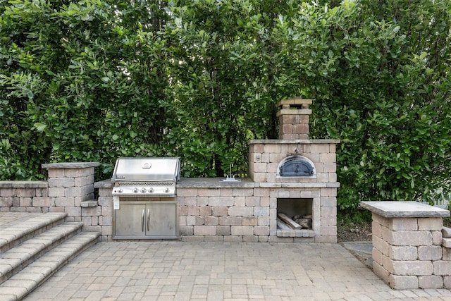 508 W 5th St, Vinton, IA 52349 - view of patio / terrace featuring an outdoor stone fireplace