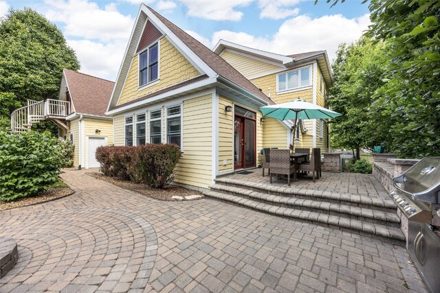 508 W 5th St, Vinton, IA 52349 - view of front of home with a patio, stairway, and outdoor dining area