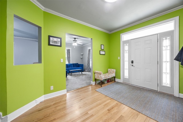 508 W 5th St, Vinton, IA 52349 - entrance foyer featuring ornamental molding, baseboards, wood finished floors, and a ceiling fan