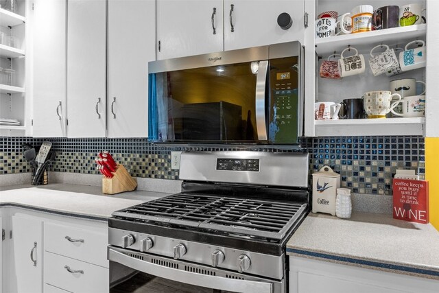 508 W 5th St, Vinton, IA 52349 - kitchen featuring open shelves, stainless steel appliances, white cabinets, and tasteful backsplash