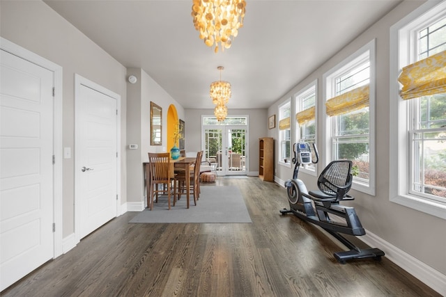 508 W 5th St, Vinton, IA 52349 - exercise room featuring a chandelier, wood finished floors, baseboards, and french doors