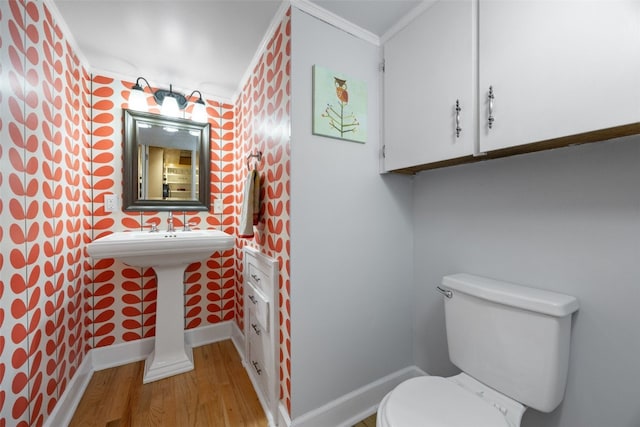 508 W 5th St, Vinton, IA 52349 - bathroom with wallpapered walls, baseboards, wood finished floors, toilet, and ornamental molding