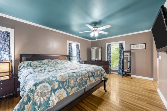508 W 5th St, Vinton, IA 52349 - bedroom featuring baseboards, wood finished floors, ornamental molding, and ceiling fan