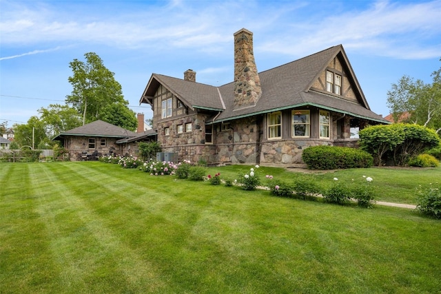 1900 Linden Dr SE, Cedar Rapids, IA 52403 - view of home's exterior featuring stone siding, a lawn, a chimney, and central AC