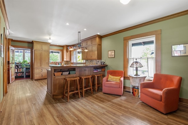 1900 Linden Dr SE, Cedar Rapids, IA 52403 - kitchen with light wood-type flooring, crown molding, a peninsula, recessed lighting, and tasteful backsplash