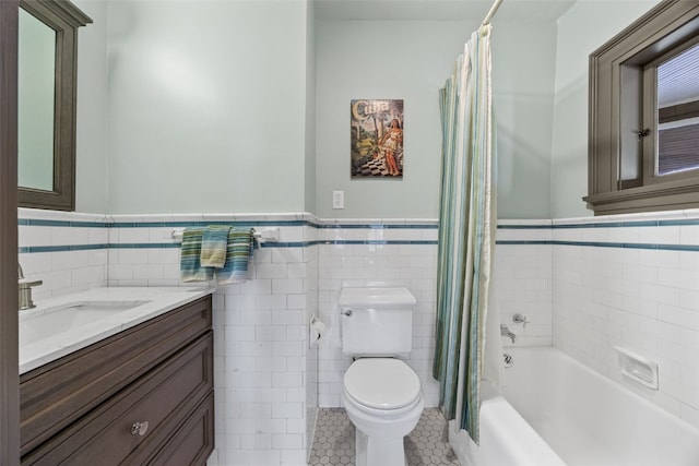 1900 Linden Dr SE, Cedar Rapids, IA 52403 - full bath with tile walls, toilet, wainscoting, vanity, and tile patterned flooring