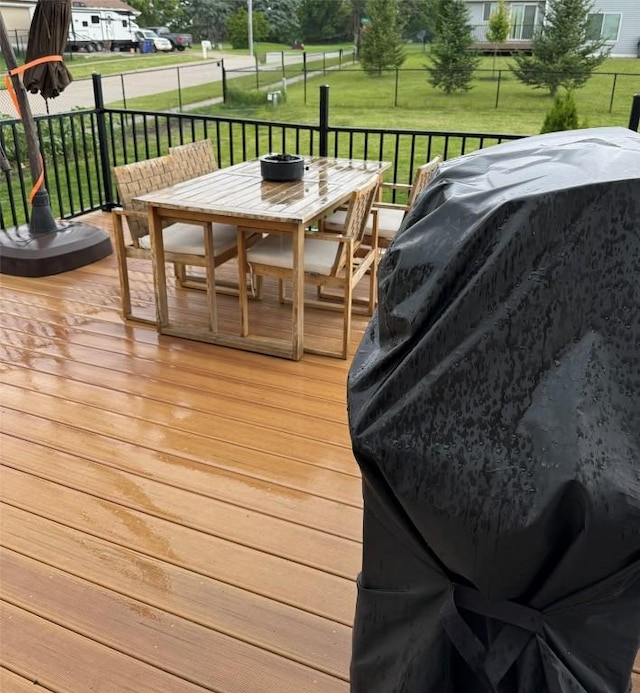 828 73rd NE, Cedar Rapids, IA 52402 - wooden deck featuring outdoor dining area and a yard