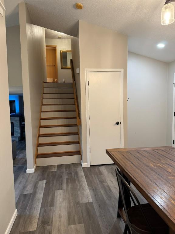828 73rd NE, Cedar Rapids, IA 52402 - staircase with wood finished floors and a fireplace