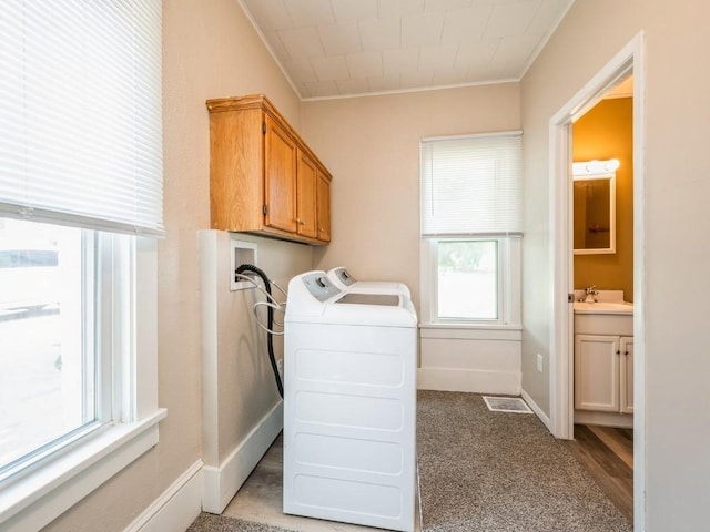 207 Prospect St NW, Blairstown, IA 52209 - washroom with cabinet space, ornamental molding, and washer and dryer