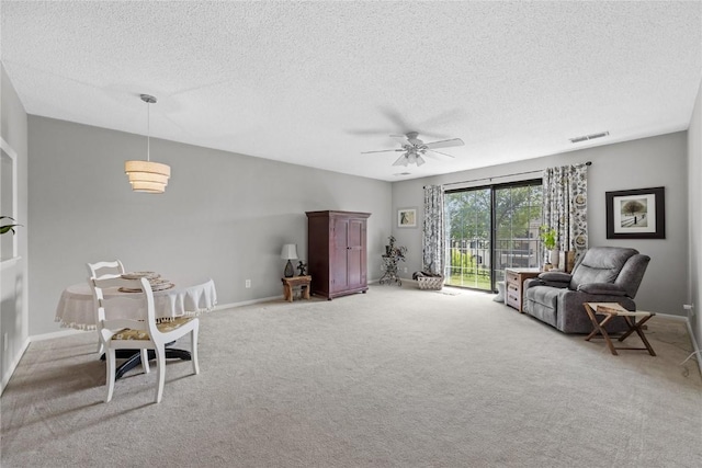 130 Thompson Dr SE Unit 320, Cedar Rapids, IA 52403 - living area with a textured ceiling, light colored carpet, and ceiling fan