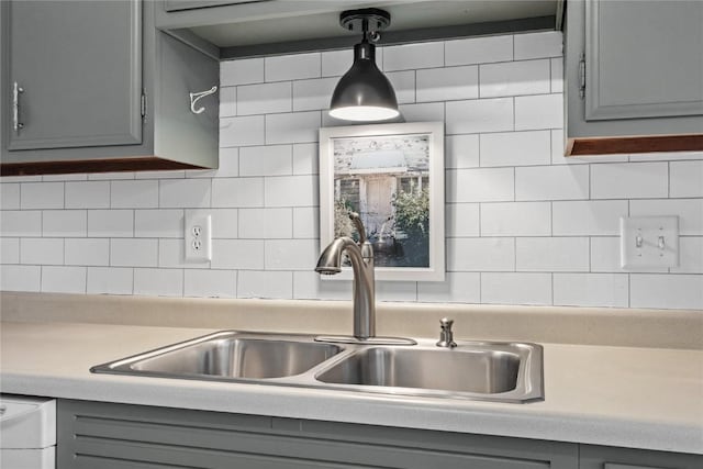 130 Thompson Dr SE Unit 320, Cedar Rapids, IA 52403 - kitchen featuring gray cabinets, light countertops, tasteful backsplash, and dishwasher