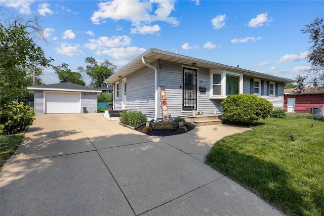 3622 14th Ave SE, Cedar Rapids, IA 52403 - view of front facade with an outdoor structure, a detached garage, a front yard, and concrete driveway