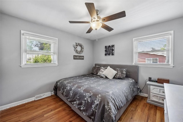 3622 14th Ave SE, Cedar Rapids, IA 52403 - bedroom featuring multiple windows, wood finished floors, and ceiling fan