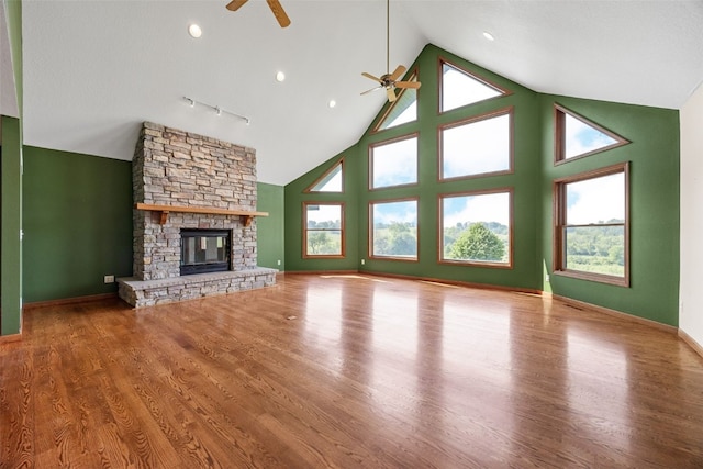 660 Garfield Rd, West Branch, IA 52358 - unfurnished living room featuring a ceiling fan, a fireplace, high vaulted ceiling, and wood finished floors