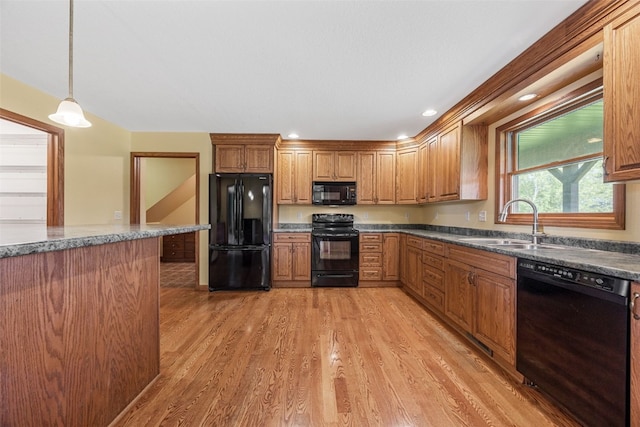 660 Garfield Rd, West Branch, IA 52358 - kitchen with black appliances, light wood-type flooring, hanging light fixtures, brown cabinets, and recessed lighting