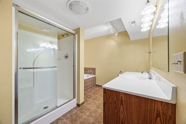 660 Garfield Rd, West Branch, IA 52358 - full bathroom with a shower stall, a garden tub, tile patterned flooring, vanity, and track lighting