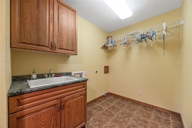 660 Garfield Rd, West Branch, IA 52358 - laundry room with electric dryer hookup, washer hookup, cabinet space, and a textured ceiling