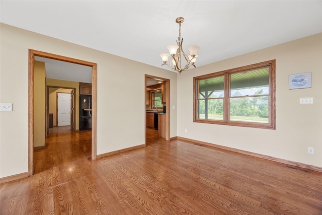 660 Garfield Rd, West Branch, IA 52358 - spare room featuring a chandelier and wood finished floors