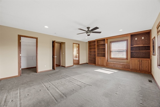660 Garfield Rd, West Branch, IA 52358 - unfurnished living room featuring light carpet, a ceiling fan, recessed lighting, and built in features