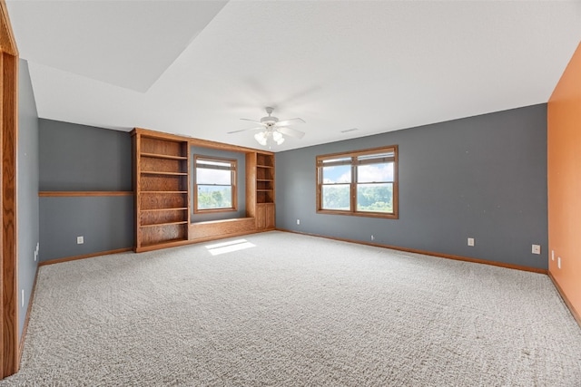660 Garfield Rd, West Branch, IA 52358 - spare room featuring carpet flooring, a ceiling fan, and built in features