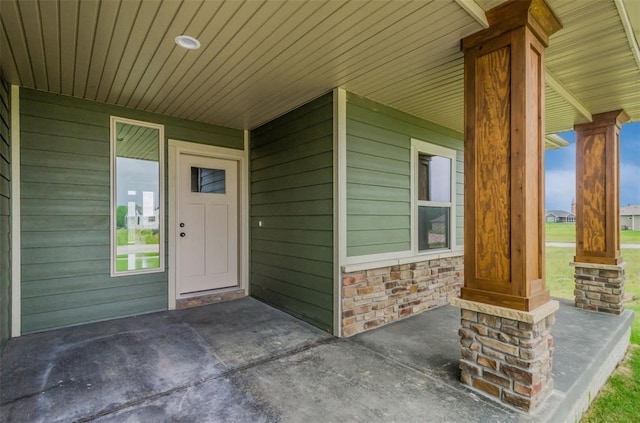 1529 3rd St SW, Mount Vernon, IA 52314 - doorway to property with covered porch and stone siding