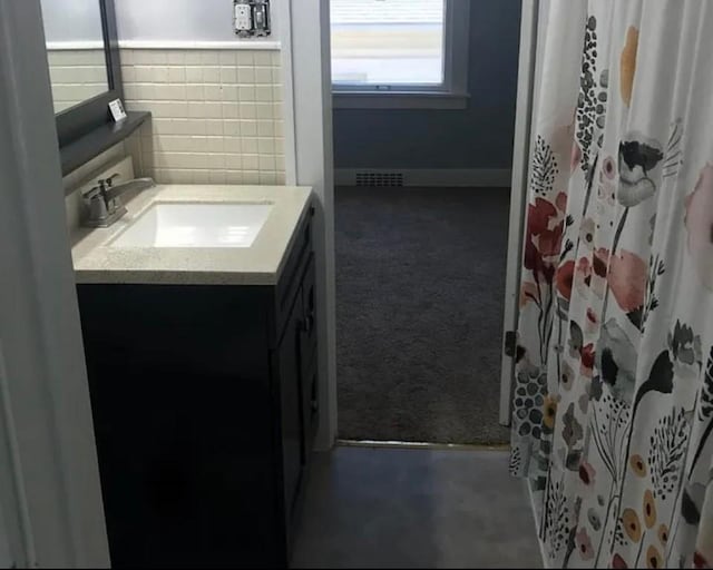 129 13th St NW, Cedar Rapids, IA 52405 - bathroom with vanity and tile walls