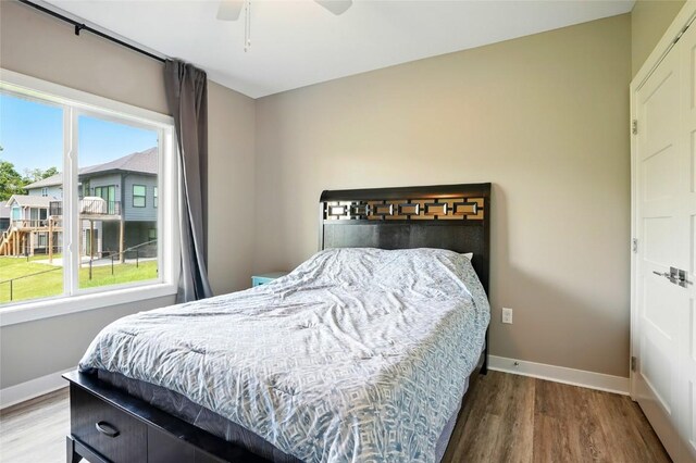 1643 Avalon Pl, Iowa City, IA 52245 - bedroom with wood finished floors, multiple windows, and a ceiling fan
