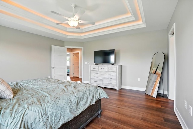 1643 Avalon Pl, Iowa City, IA 52245 - bedroom featuring a tray ceiling, dark wood-style flooring, and a ceiling fan
