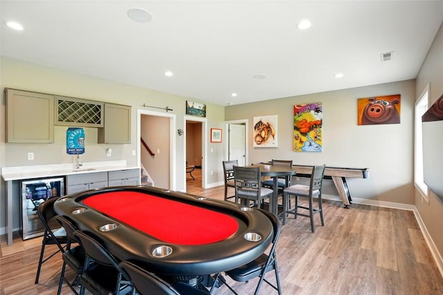 1643 Avalon Pl, Iowa City, IA 52245 - recreation room with beverage cooler, bar with sink, light wood finished floors, recessed lighting, and healthy amount of natural light